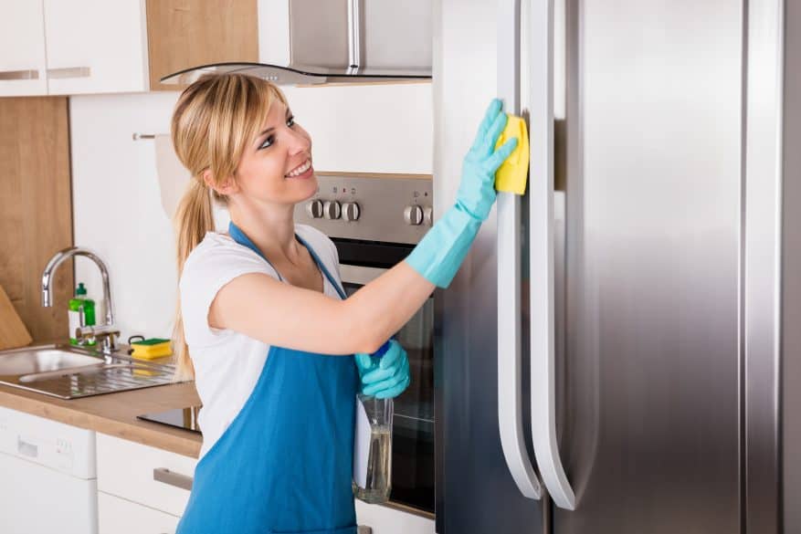 woman cleaning fridge