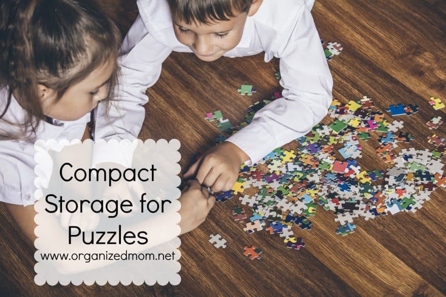 Happy boy and girl collect puzzle lying on the floor closeup