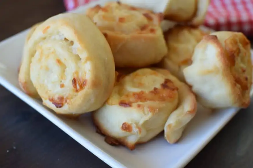 close up of pizza crust doodles with cheese