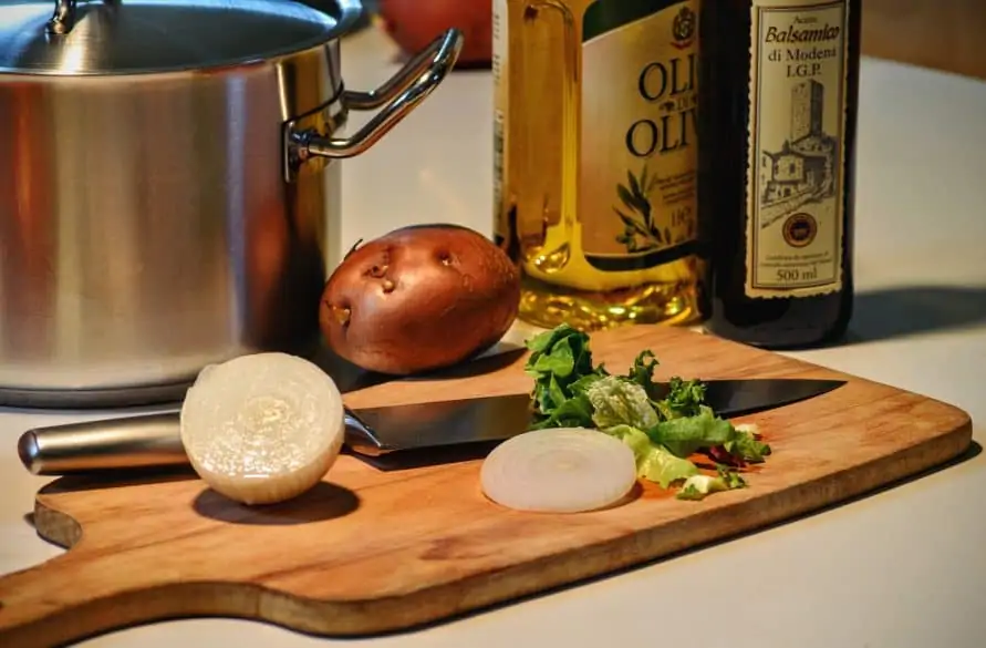 cutting onions on wooden cutting board