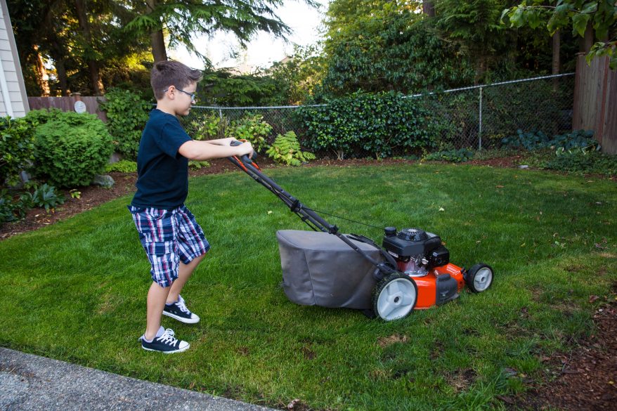 child mowing lawn