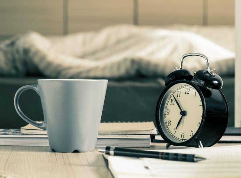 alarm clock and coffee cup