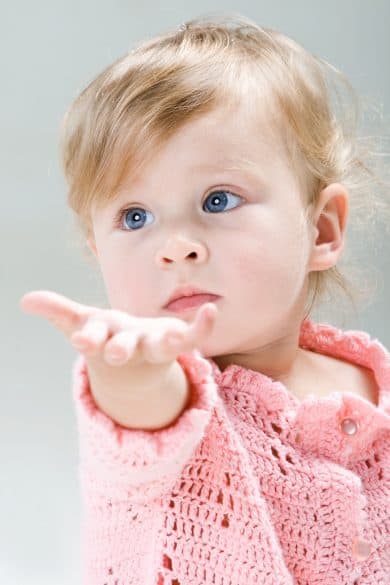 little girl reaching out hand