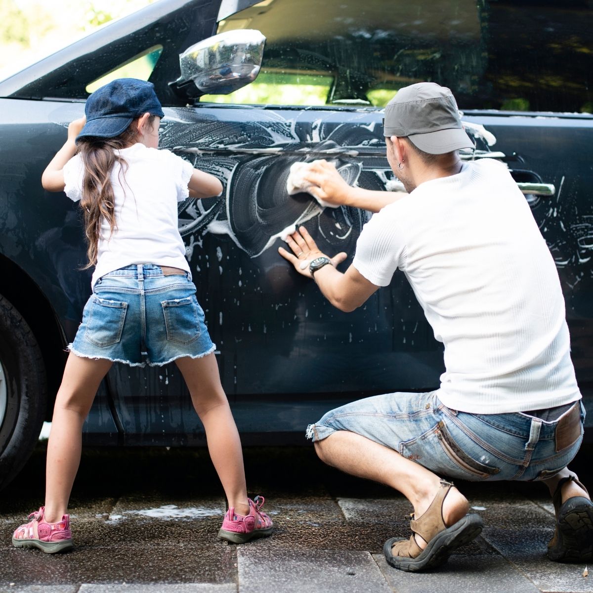 father and child washing car