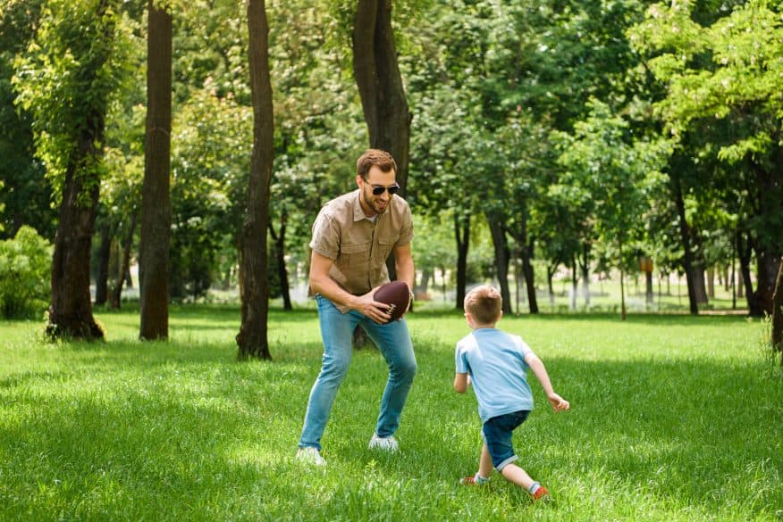 father son playing football