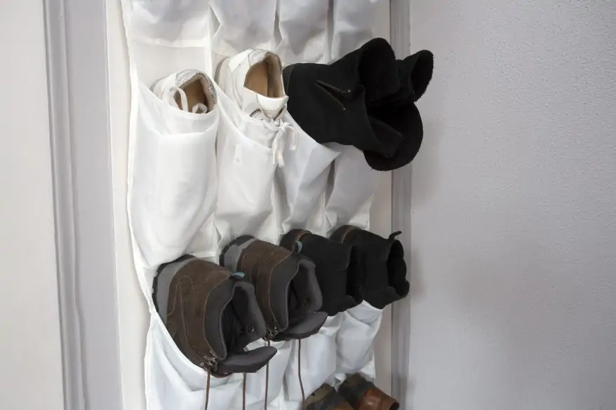 Shoe rack hanging on a wooden door, storage for shoes close-up shoe organization ideas