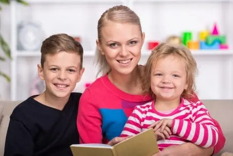 Young mother and her two children are reading a book together find satisfaction in being organized