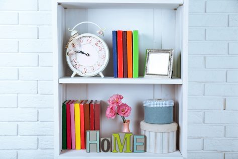 Books and decor on shelves in cupboard