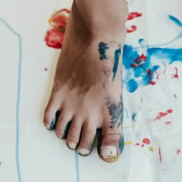 child's foot covered in paint; preschool education options