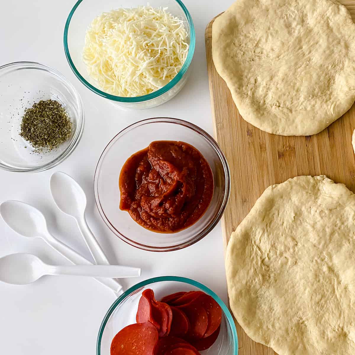 assembling pizzas for party