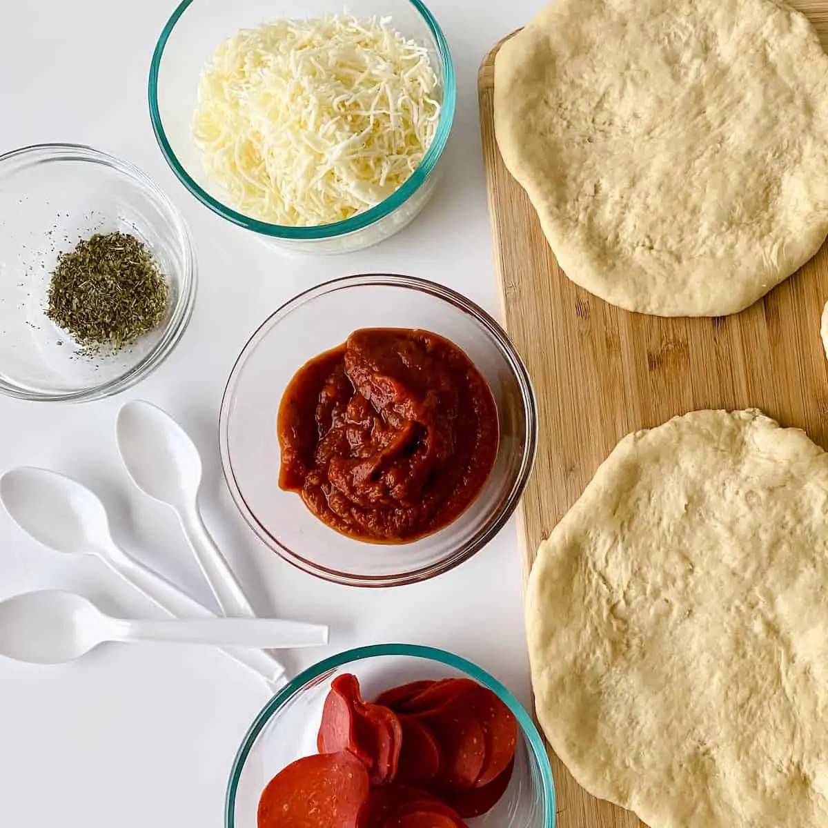 assembling pizzas for party