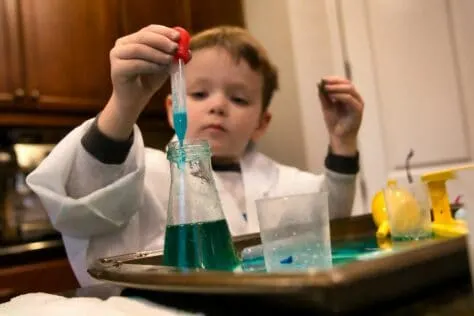 Boy with science experiment subscription gift ideas for kids