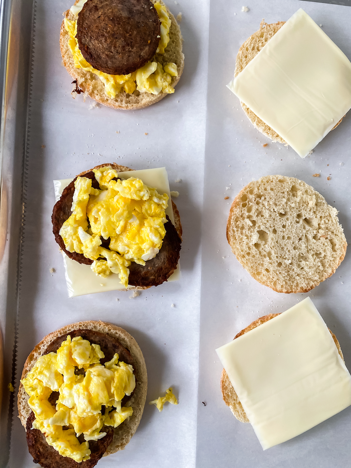 putting together homemade English muffins on sheet pans