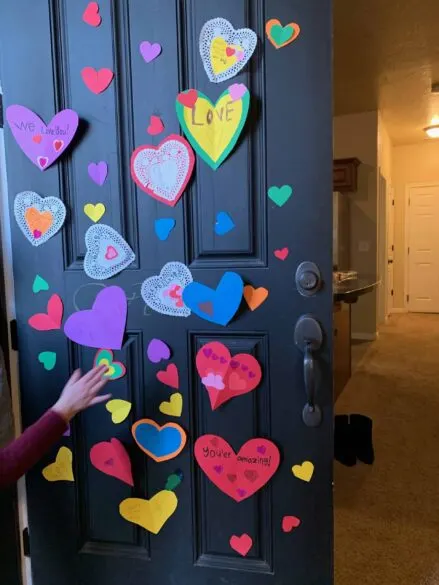 Door with paper hearts taped to it.