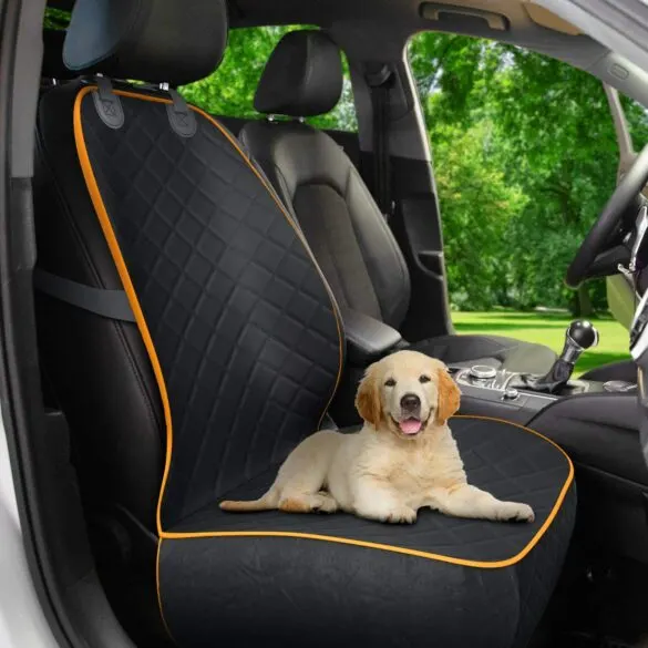 Dog sitting in the front seat on a seat protector.