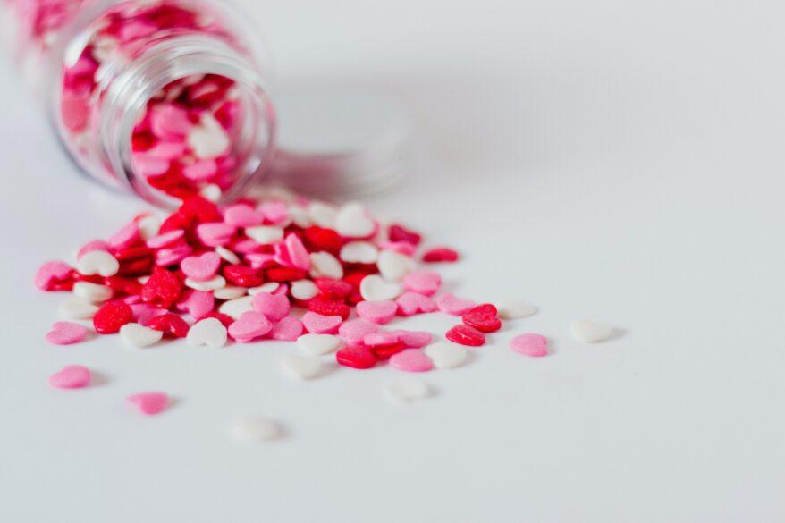 Jar with candy hearts spilling from it.