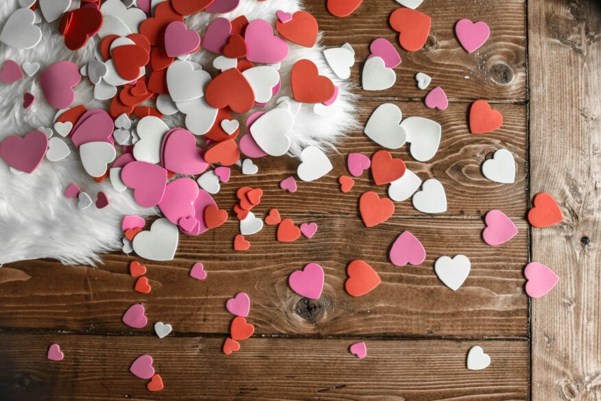 A table with paper hearts scattered on it.