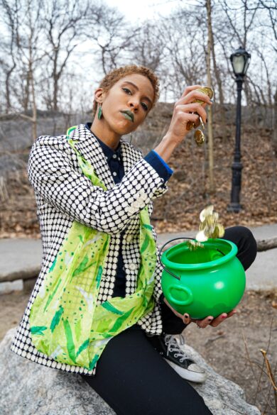 Girl holding a pot and gold coins.