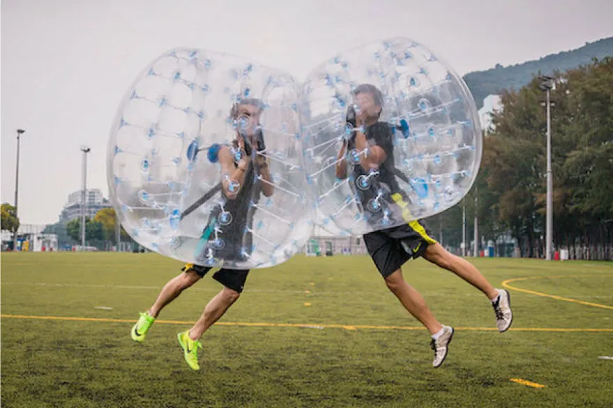 2 kids bumping together in bubble balls.