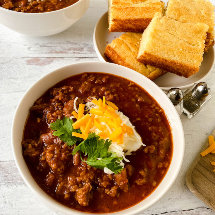 bowl of pork chili and cornbread