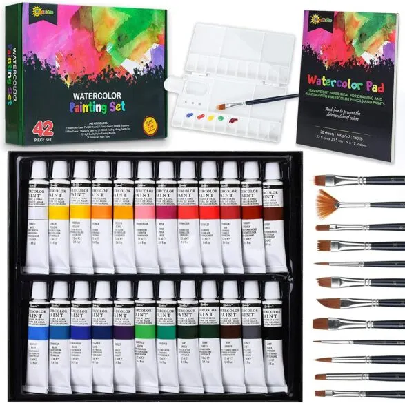 A watercolor set including brushes, paints, paper and a palette.
