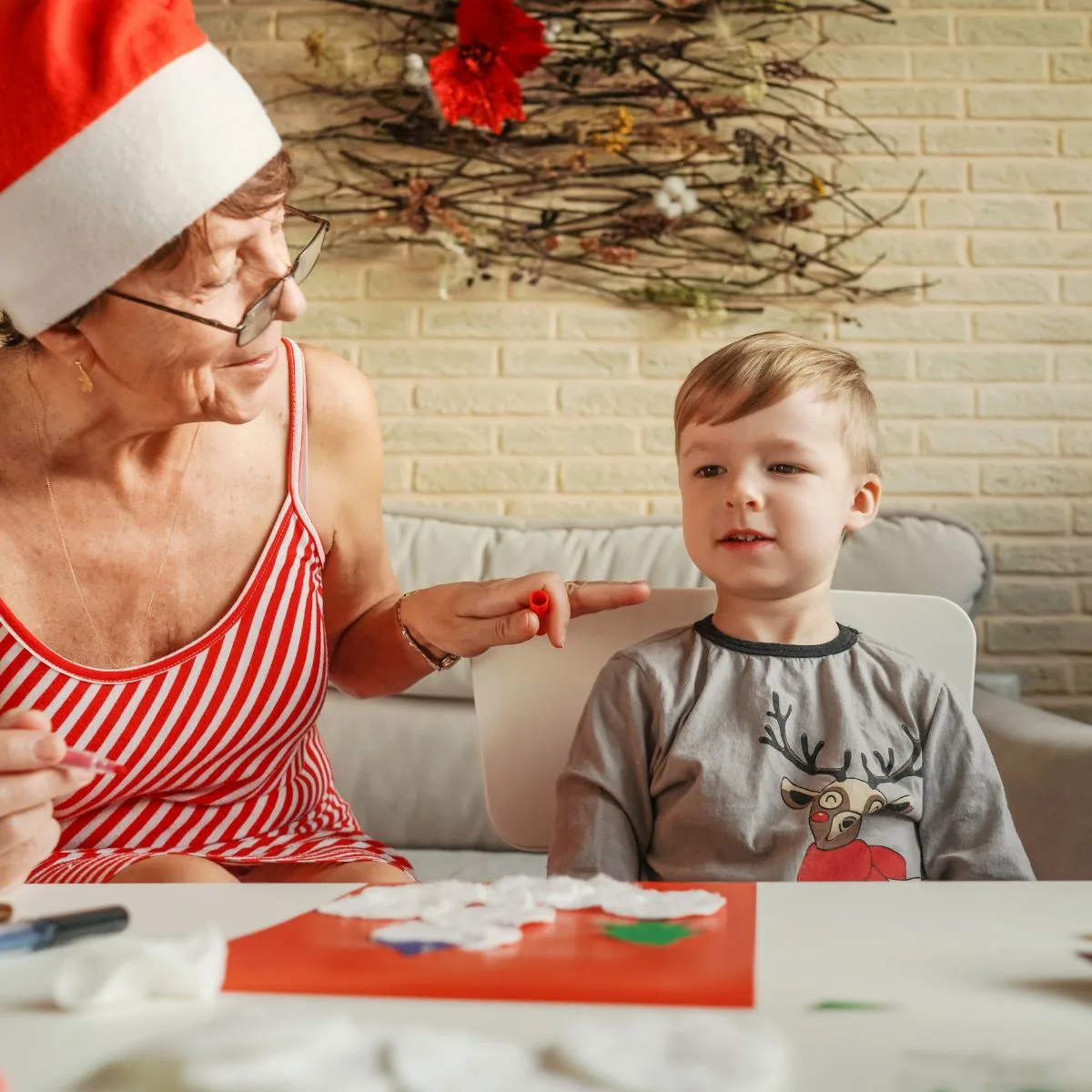 grandmother and grandson doing christmas crafts