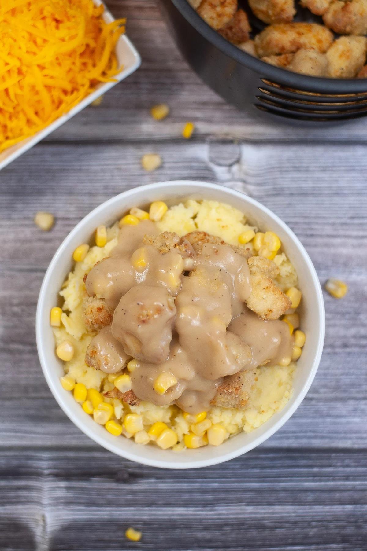 making copycat kfc bowl adding gravy and corn