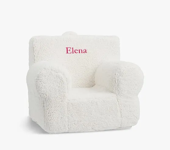 A picture of a child size fluffy chair with the name Elena on it.