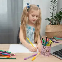 girl doing school work; homeschool curriculum for working mom