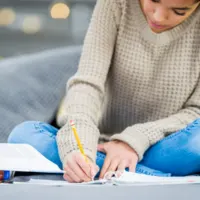 teen doing homework; How to Teach Homeschool Language Arts