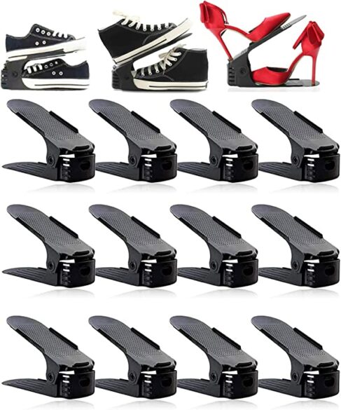 A set of shoe slot organizers with different sized shoes on them.