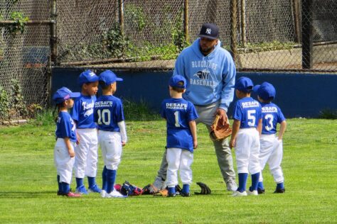 coach with baseball team; Organized Youth Sports