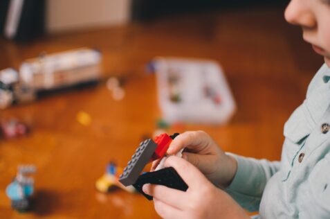 kid playing with lego