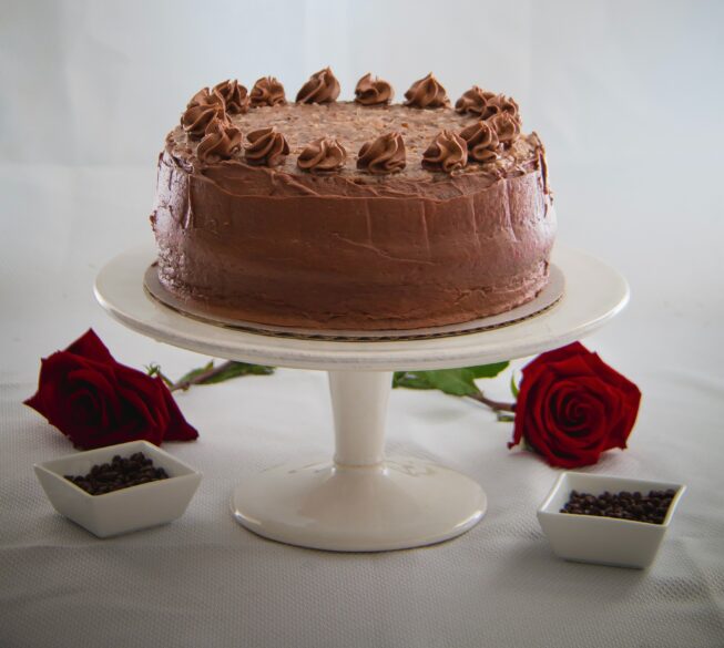 A German Chocolate Cake on a cake stand.