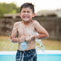 Boy playing with water baloon