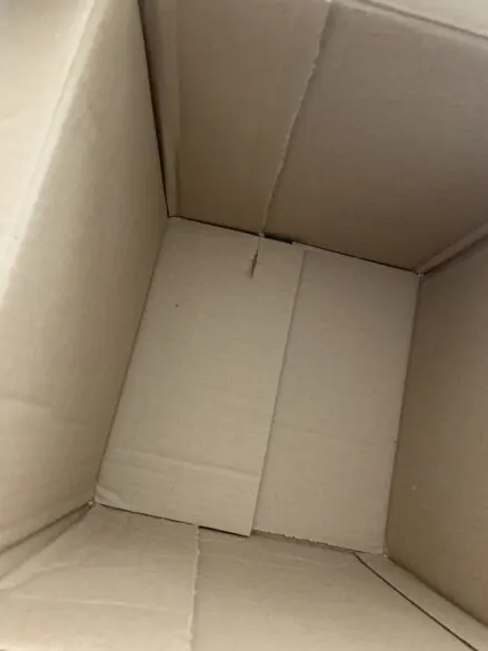 A cardboard box cut and repositioned to make a square.