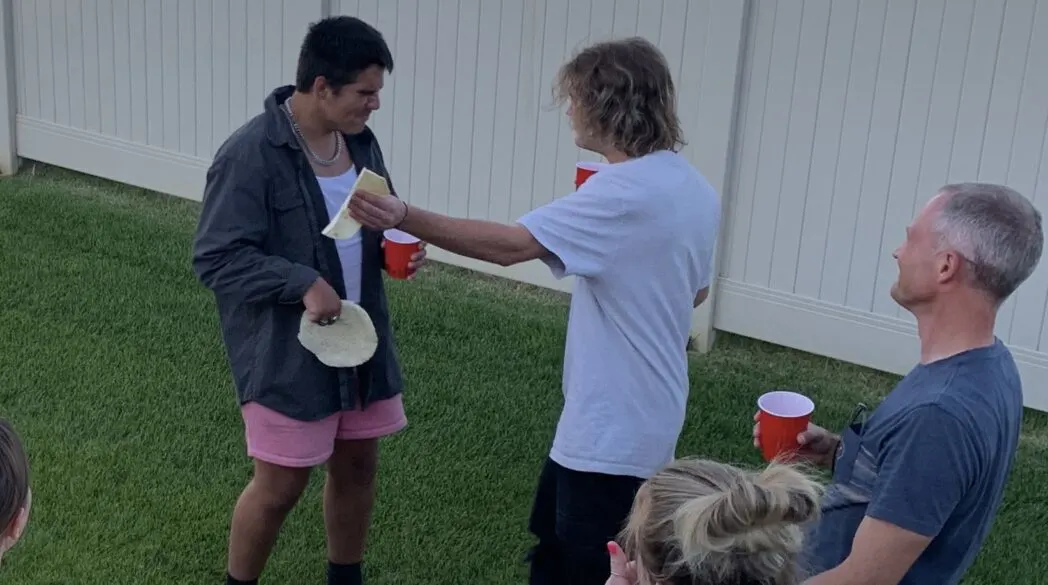 One person slapping another person with a tortilla.