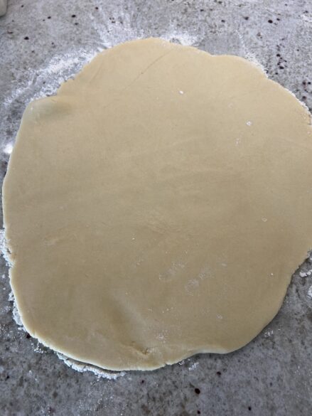 Dough rolled out and ready to be cut with cookie cutters.