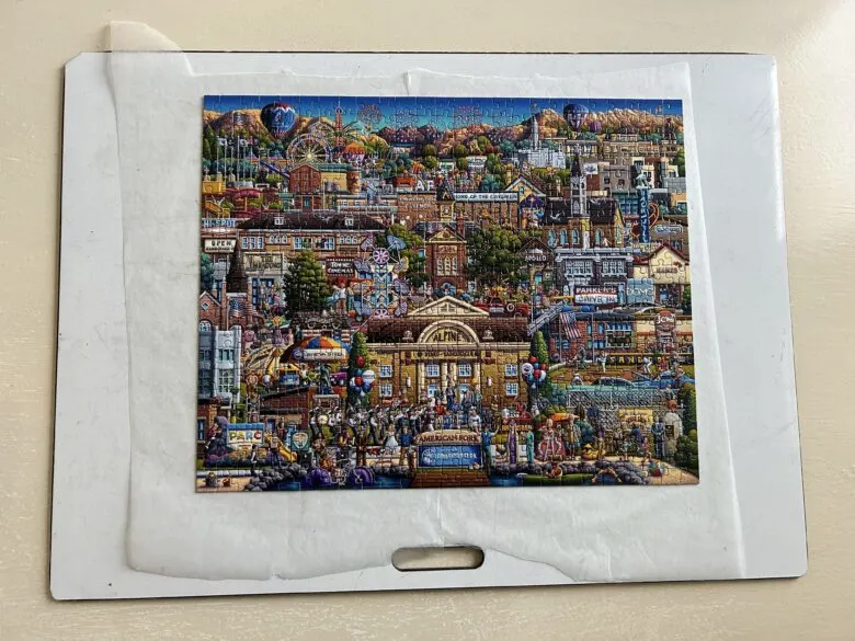 A finished puzzle with wax paper slide underneath it.