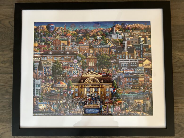 A finished puzzle that is glued together and framed.