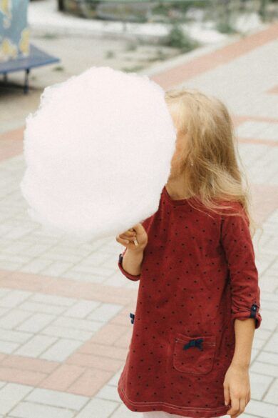 A young girl holding cotton candy; Party Ideas to Celebrate the End of School